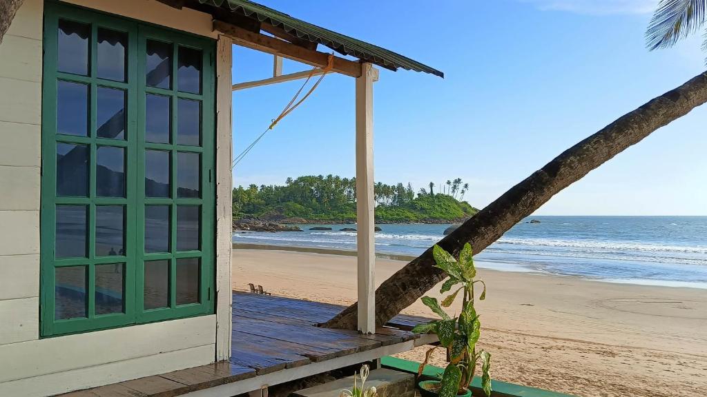 a beach house with a view of the ocean at The Nest Palolem in Canacona