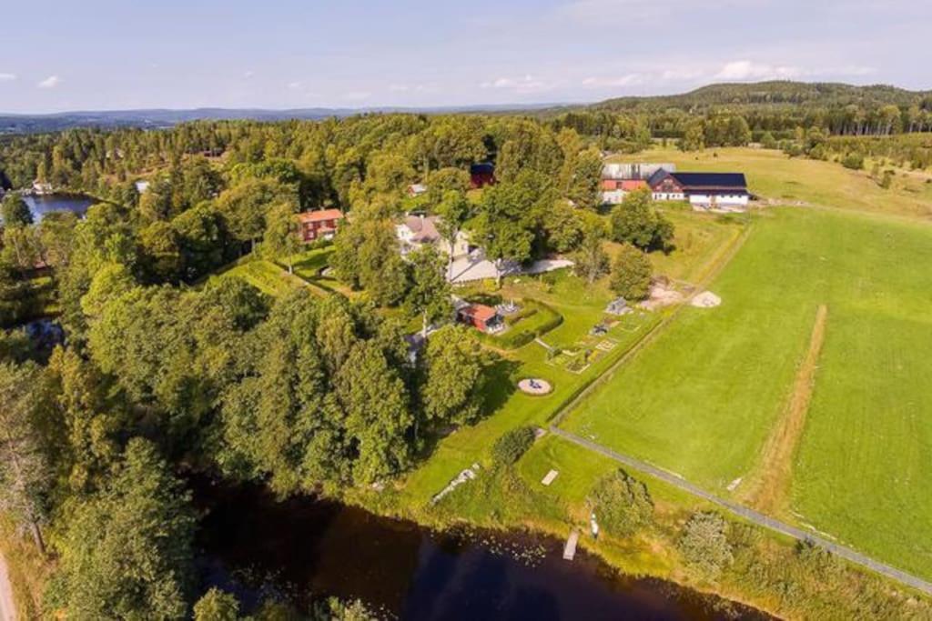 an aerial view of a house with a field and trees at Brunsbergs Herrgård appartement in Brunskog