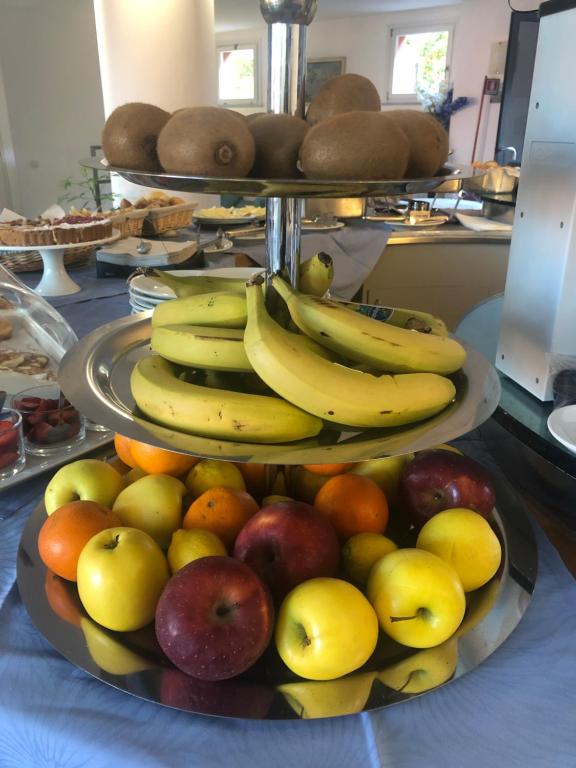 two plates of fruit on a counter with bananas apples and oranges at Baia Blu RTA Residence in Lerici