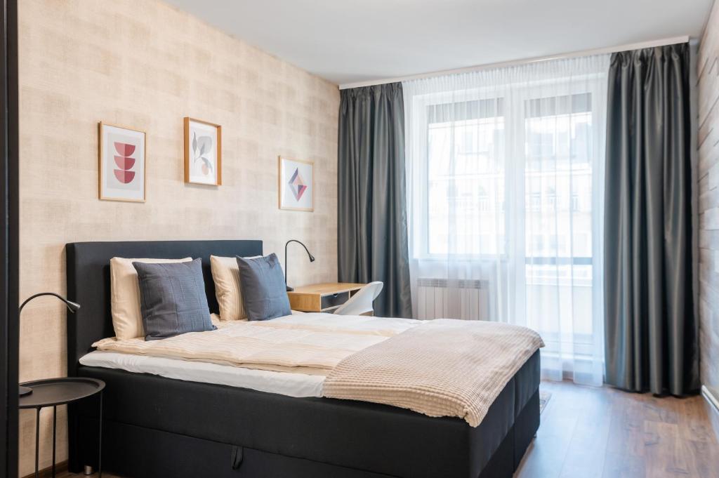 a bedroom with a large bed and a window at New Stylish 1-bedroom Flat in Business District in Sofia