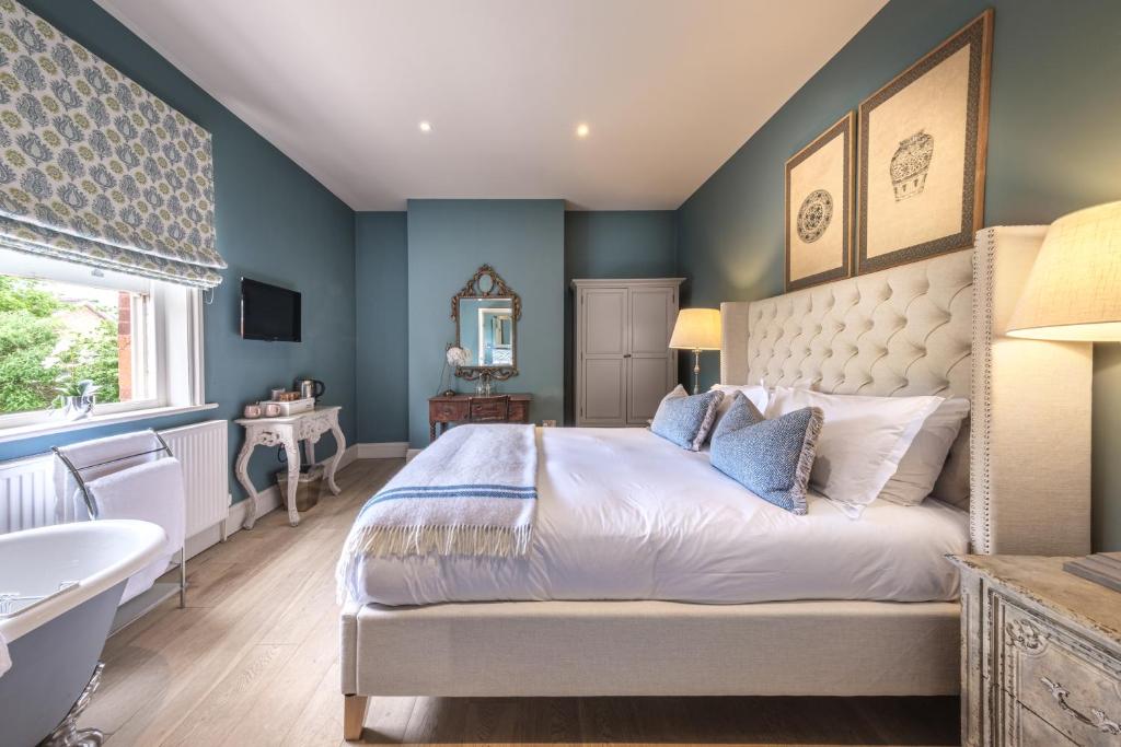 a bedroom with a king sized bed and a sink at The Packhorse Inn in Newmarket