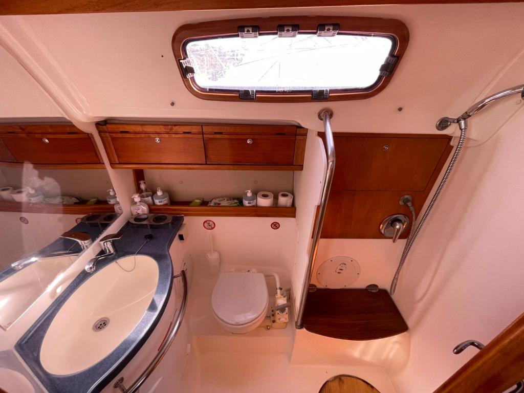 a small bathroom with a sink and a toilet at AIDA Sailing Boat in Thessaloniki