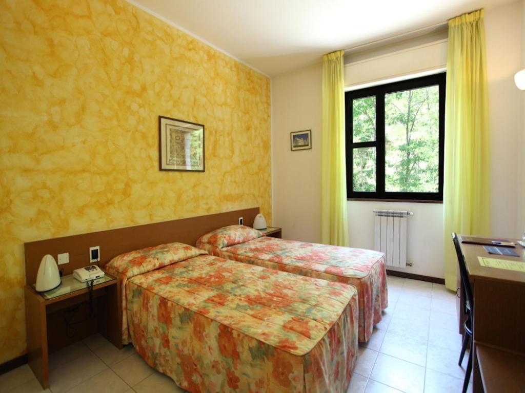 Postel nebo postele na pokoji v ubytování Euro Hotel