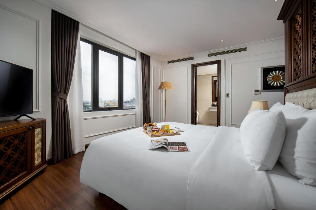 Postel nebo postele na pokoji v ubytování The Q Hotel