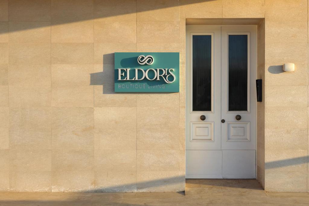 a sign on the side of a building with a door at El Doris Boutique Living in Marsaskala