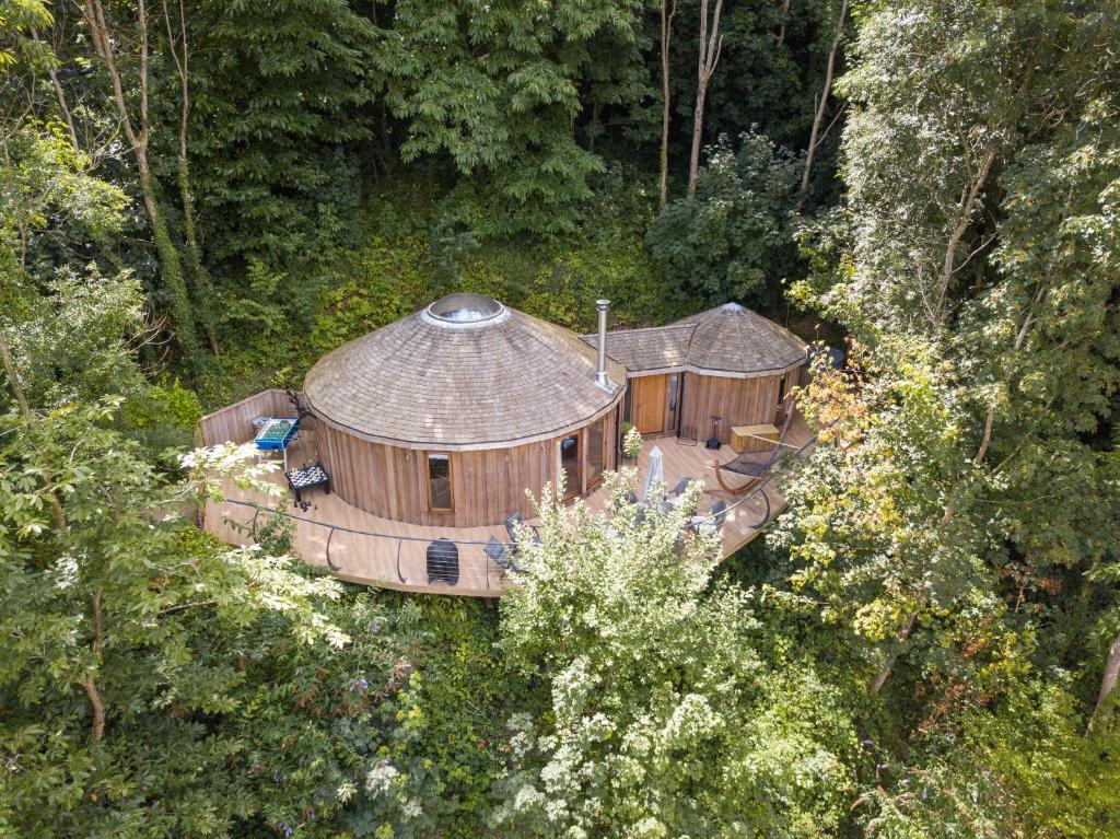 an aerial view of a large house in the forest at Woodpecker Treehouse in Dittisham