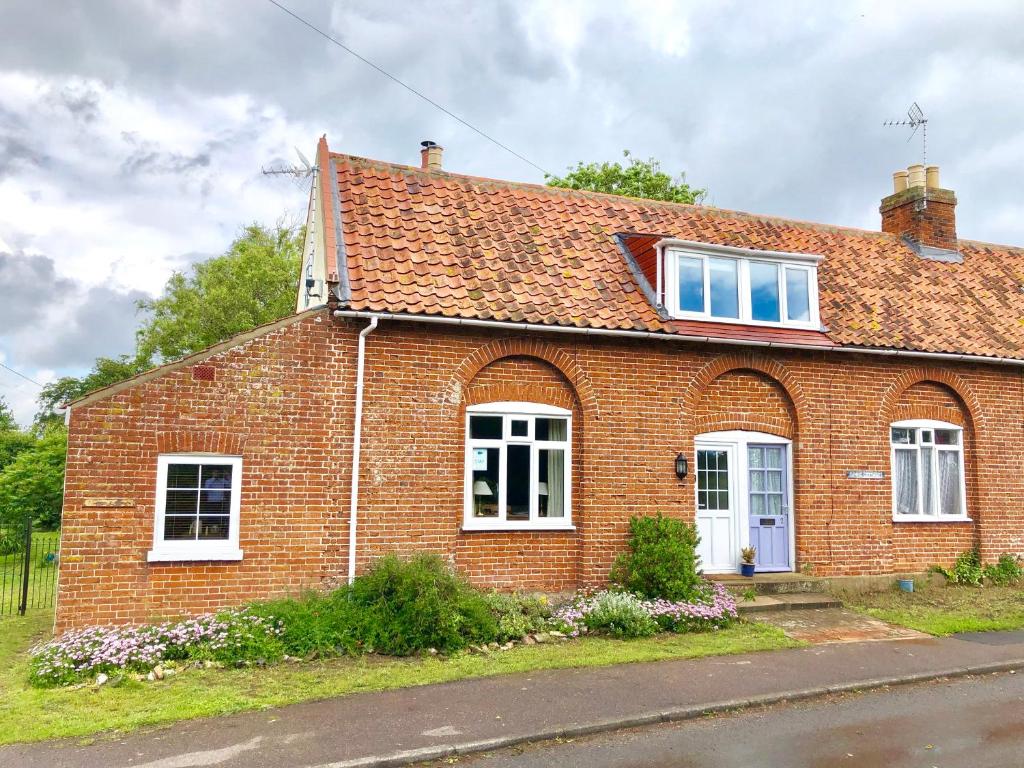 a red brick house with white windows at 1 Tunns Cottages, Rushmere, nr Beccles in Beccles