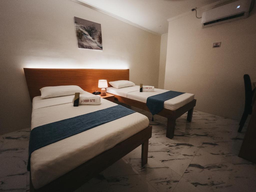 Postel nebo postele na pokoji v ubytování La Choeben Suites