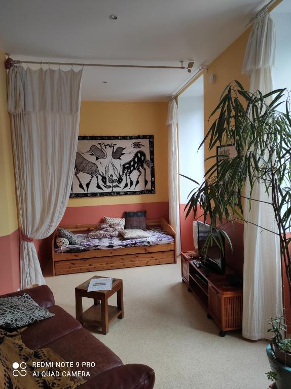 a bedroom with a bed with a picture of animals on the wall at Afrique Appartement de 42m2 à la montagne in Eaux-Bonnes