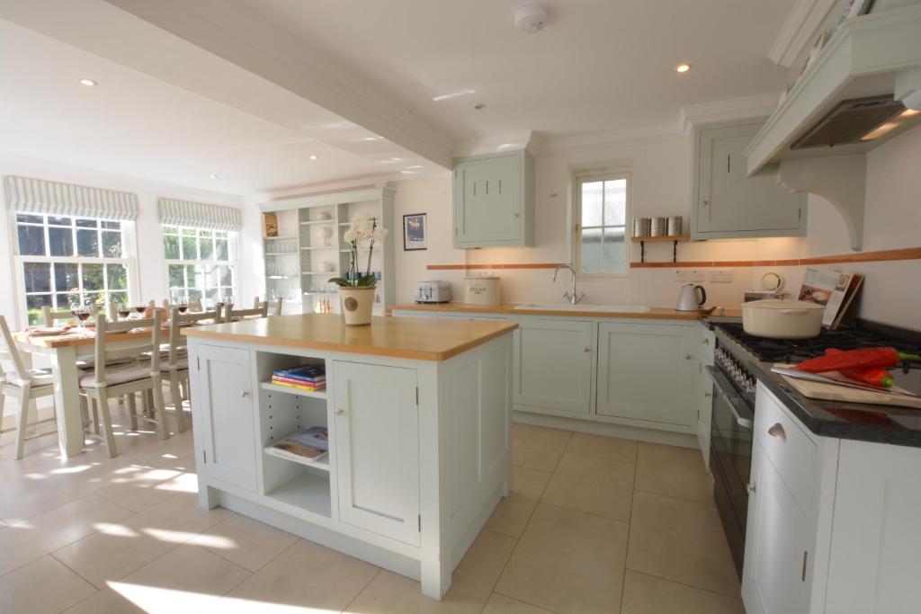 a kitchen with white cabinets and a counter top at Neptune in Aldeburgh