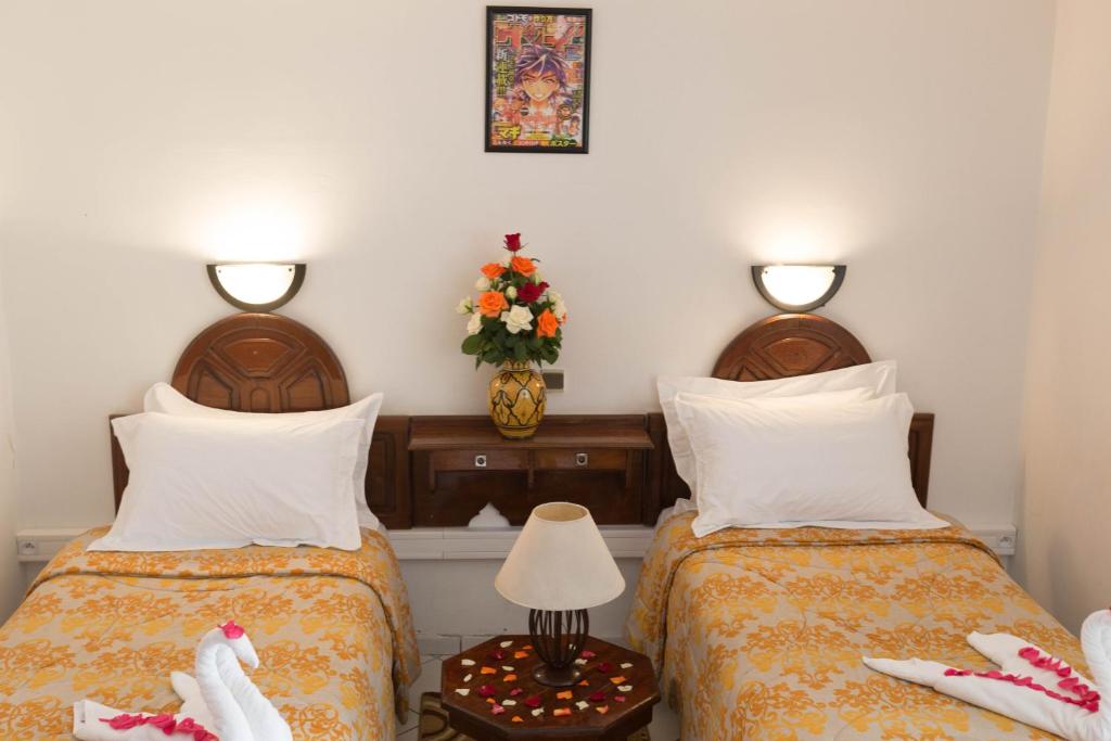 Postel nebo postele na pokoji v ubytování Hotel Sindibad