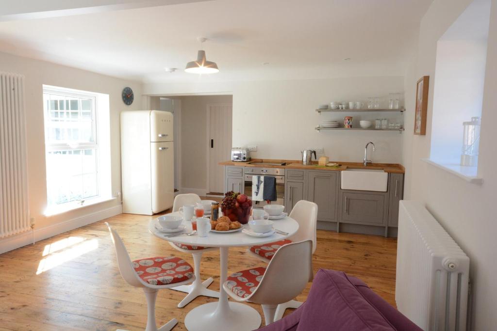 a kitchen and dining room with a table and chairs at Fig Cottage, Pettistree in Woodbridge