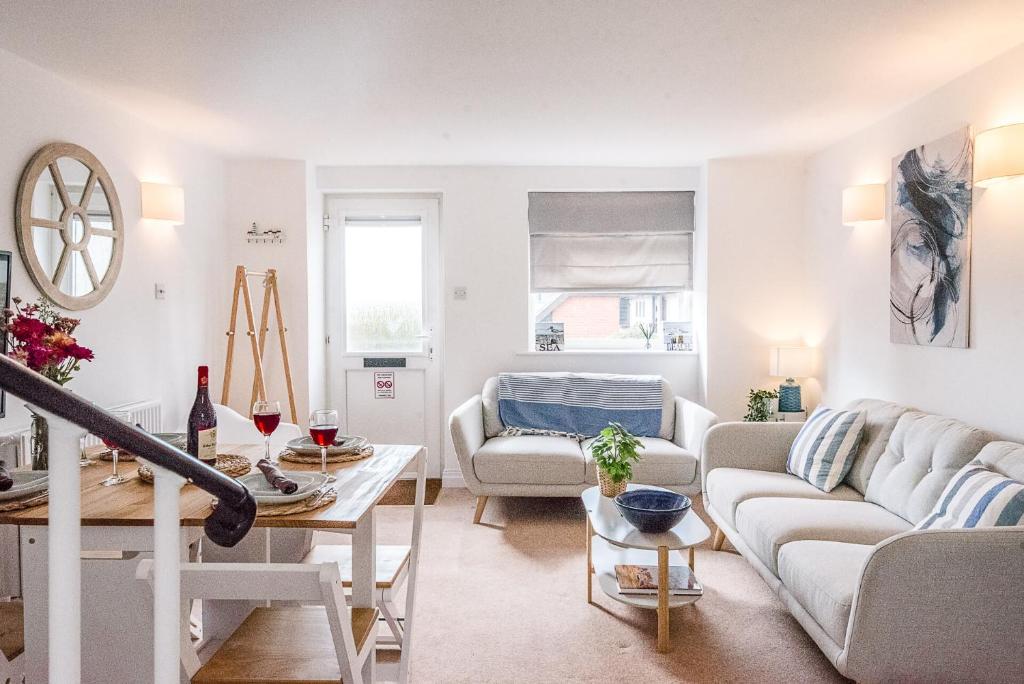 a living room with a couch and a table at Coasters, Aldeburgh in Aldeburgh