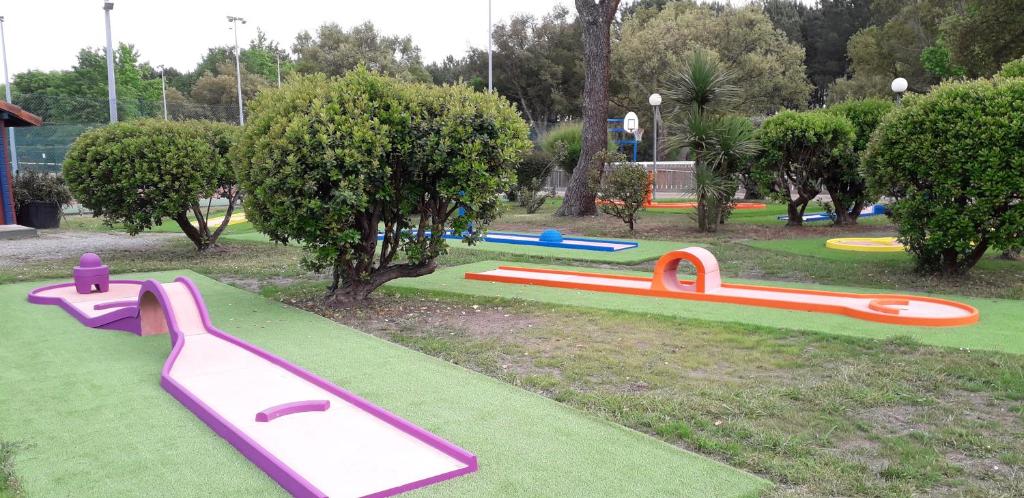 a park with colorful playground equipment on the grass at Pavillon, de 4 à 7 couchages, dans une superbe résidence avec piscine in Soustons