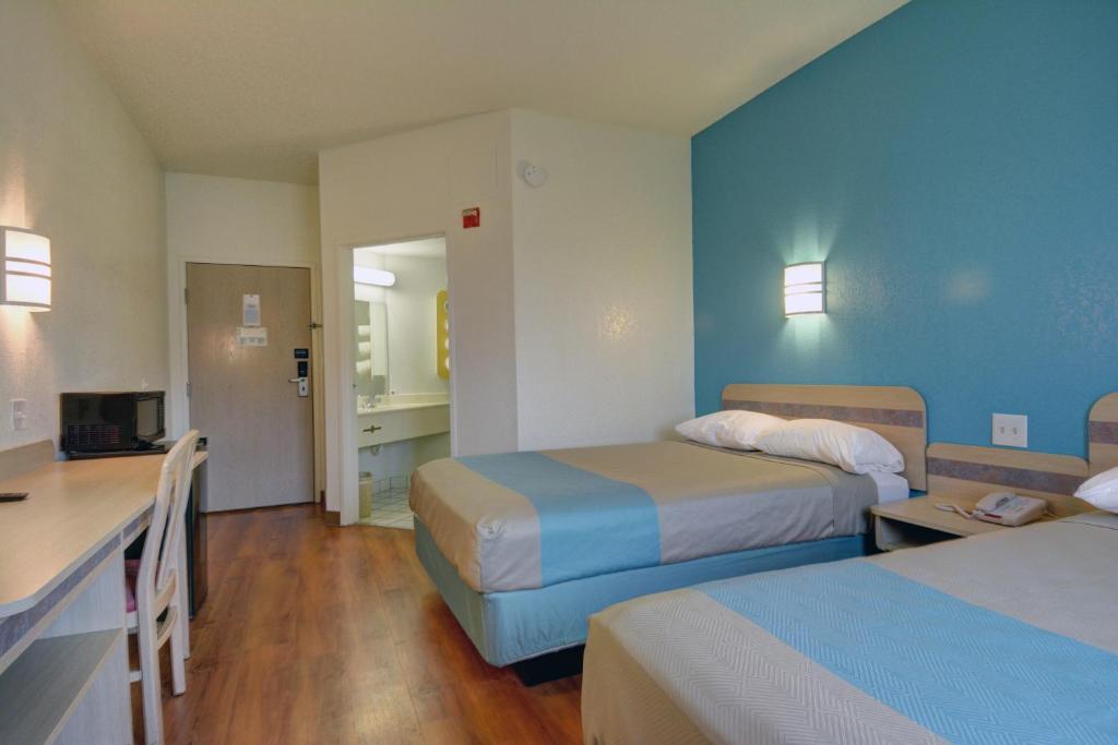 a hotel room with two beds and a kitchen at Motel 6-Denison, TX in Denison