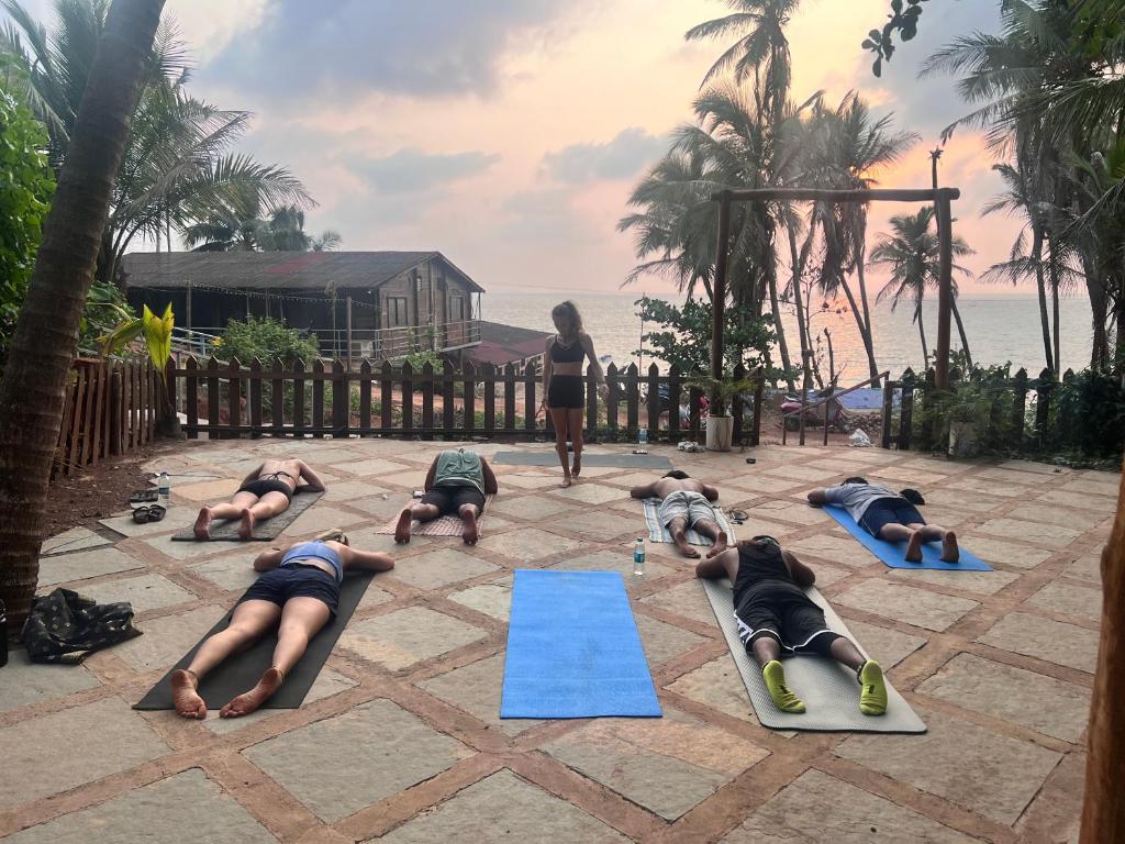 a group of people doing yoga on a patio at Beachside in Anjuna