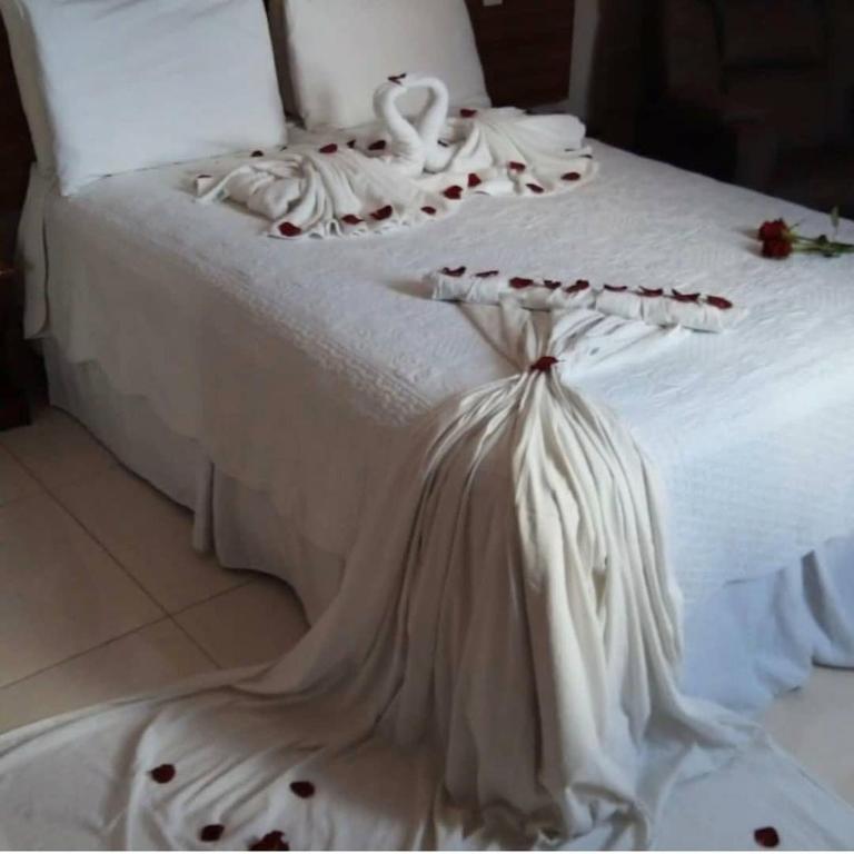 Postel nebo postele na pokoji v ubytování Jacarandá Palace Hotel
