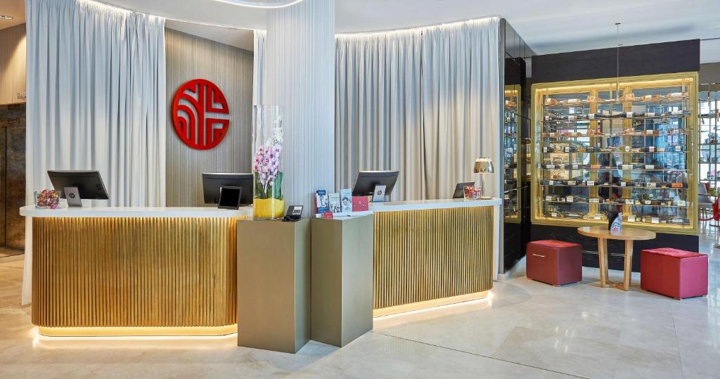 a wine store with a reception desk in a lobby at NH Collection Marseille in Marseille