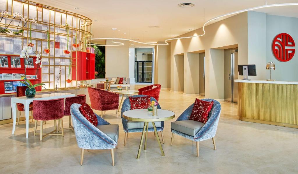 a restaurant with chairs and tables in a lobby at NH Collection Marseille in Marseille