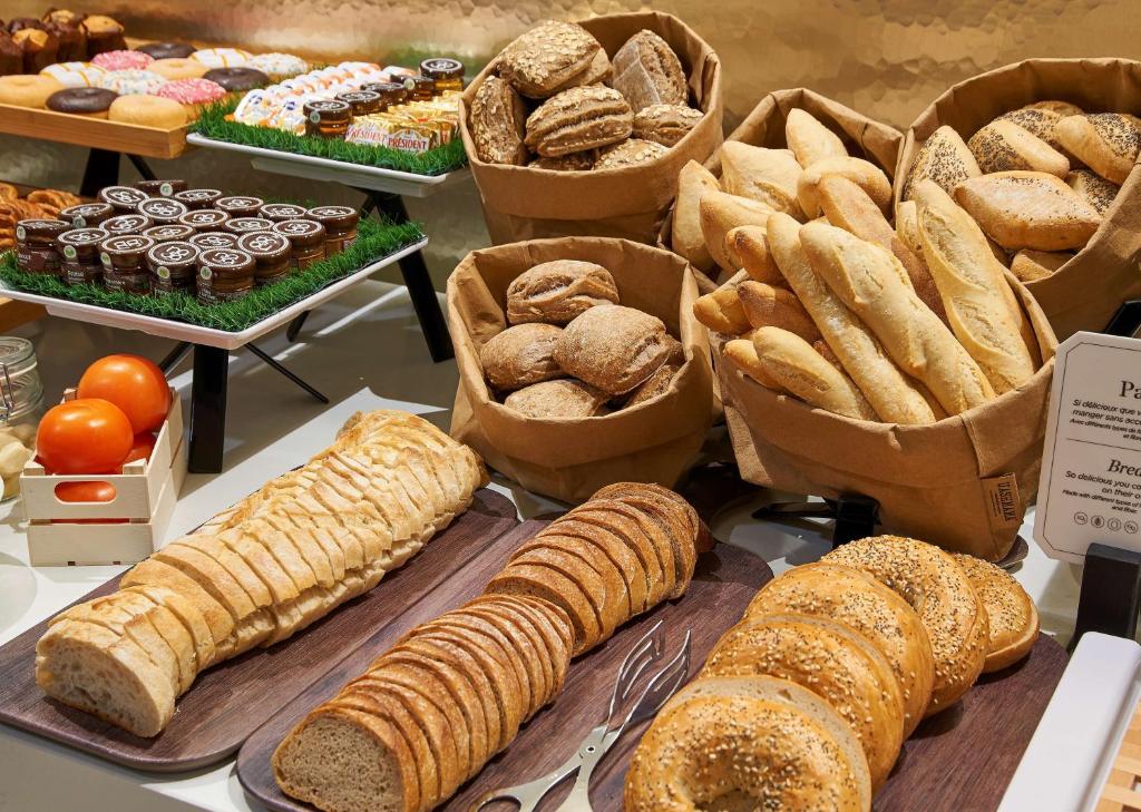 a display of different types of bread and pastries at NH Collection Marseille in Marseille