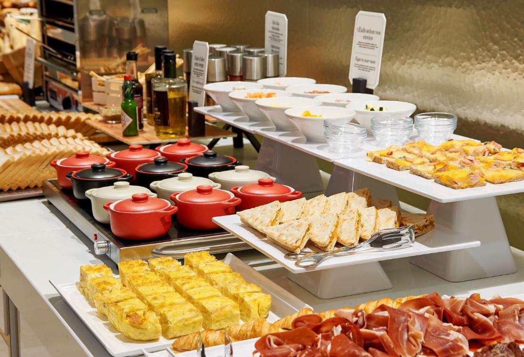 a buffet with many different types of food on display at NH Collection Marseille in Marseille