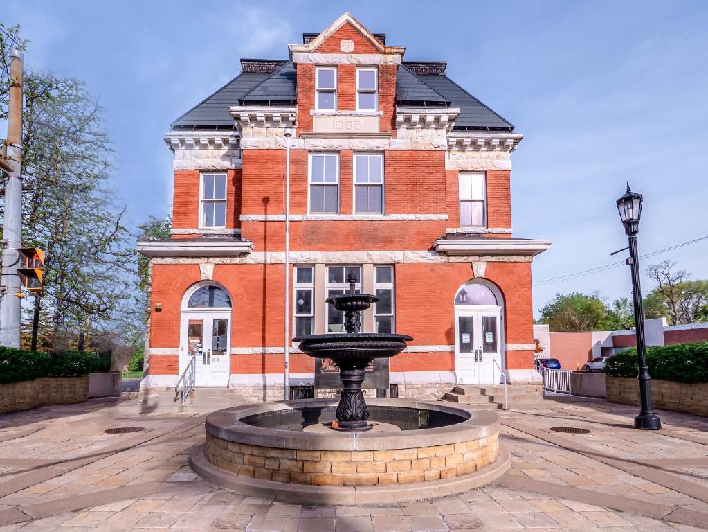 a building with a fountain in front of a building at Sandwich Boutique Hotel in Windsor