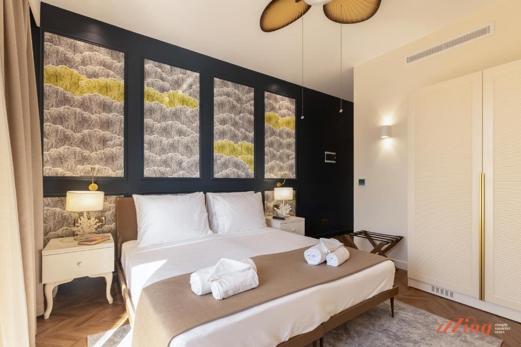 a bedroom with a bed with towels on it at El Doris Boutique Living in Marsaskala