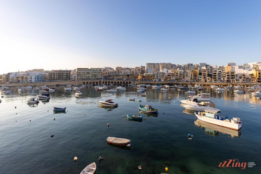 a group of boats in the water in a harbor at El Doris Boutique Living in Marsaskala