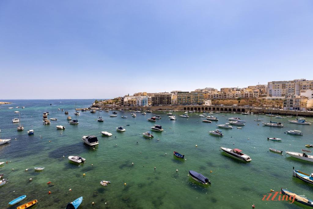 a group of boats in the water in a harbor at El Doris Boutique Living in Marsaskala