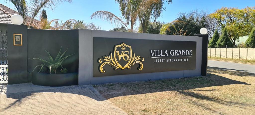 a sign for a villa gamma luxury compound at Villa Grande Luxury accommodation in Welkom