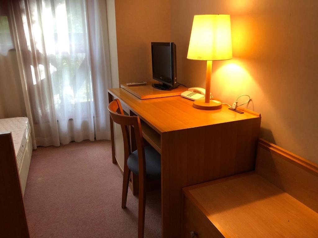 a desk with a computer and a lamp on it at Aizu Kogen International Human Resources Center - Vacation STAY 34873v in Minamiaizu