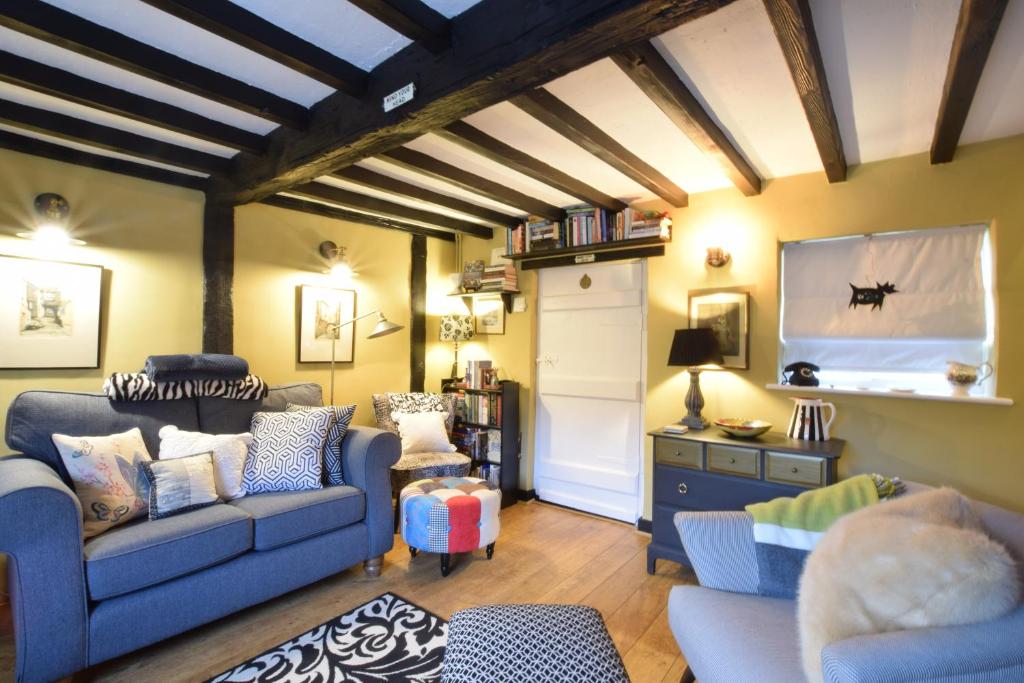 a living room with two couches and a tv at Cherry Tree Cottage, Woodbridge in Woodbridge