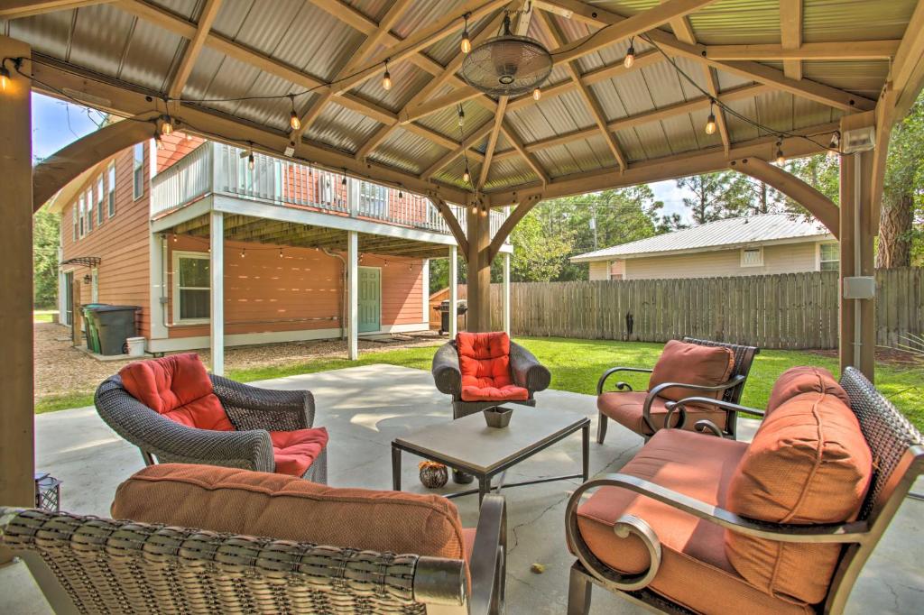 a patio with chairs and a table under a pavilion at Waveland Family House, 4-Minute Drive to the Beach in Waveland