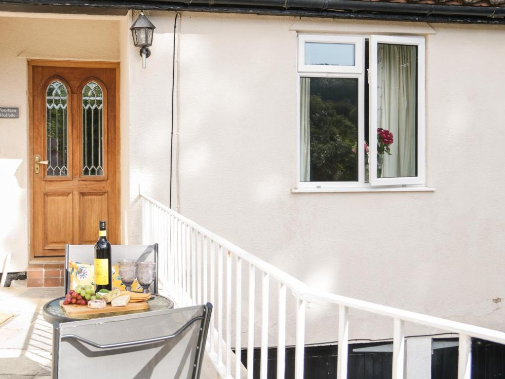 a table with a bottle of wine on a balcony at Dolphin Court in Colwyn Bay