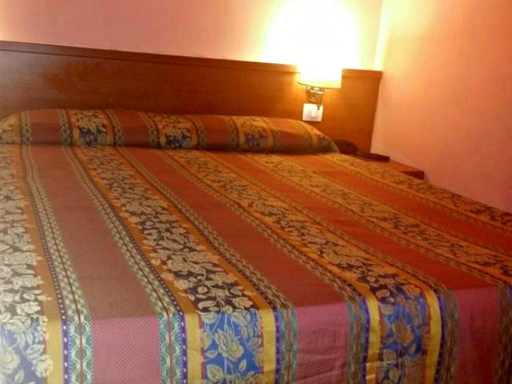 Postel nebo postele na pokoji v ubytování Hotel Lella