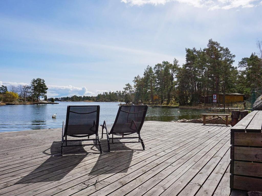 two chairs sitting on a dock next to the water at Holiday home OSKARSHAMN II in Oskarshamn