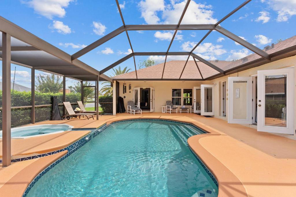 a swimming pool in a house with a glass roof at Single Family no Stairs 4BR Kissimmee OI2800 in Orlando