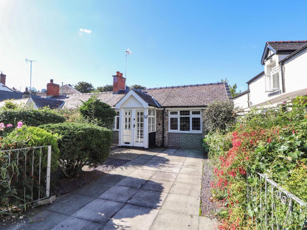 a bedroom house with a garden and a driveway at Ty Cerrig in Rhyl