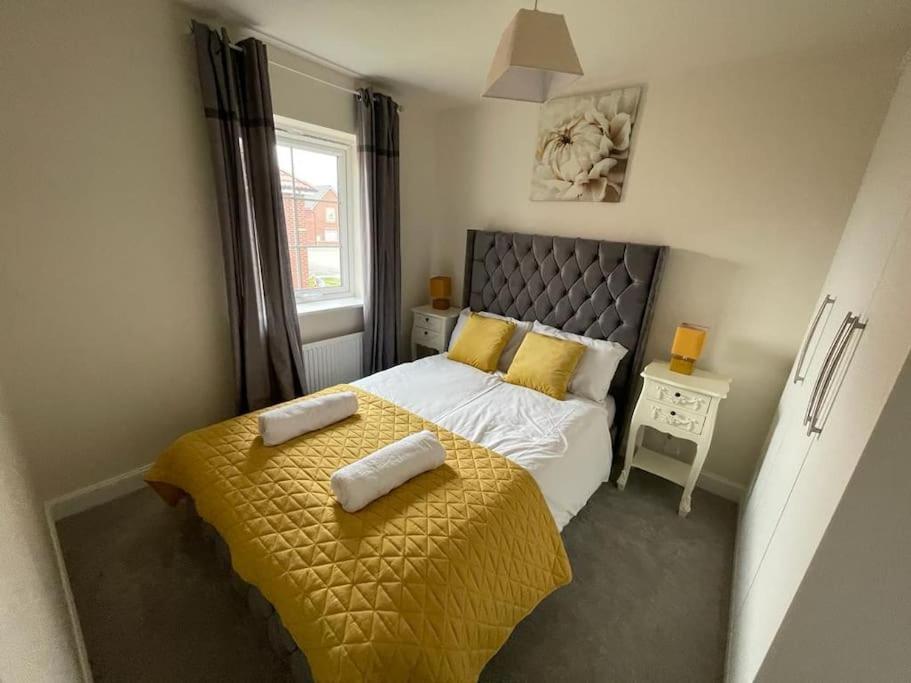 a bedroom with a bed with two towels on it at Cozy 3 bed Sasha house in Beeston Nottingham in Nottingham