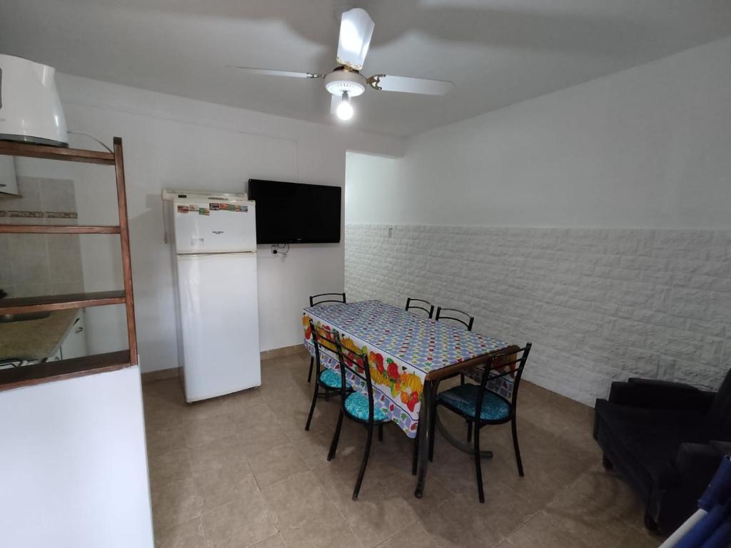 a kitchen with a table and chairs and a refrigerator at HUGO 1 in Colón