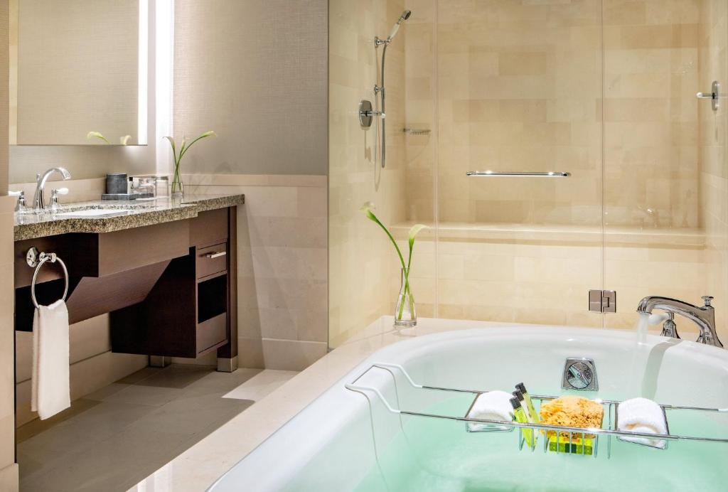 a bathroom with a bath tub and a sink at InterContinental Boston by IHG in Boston