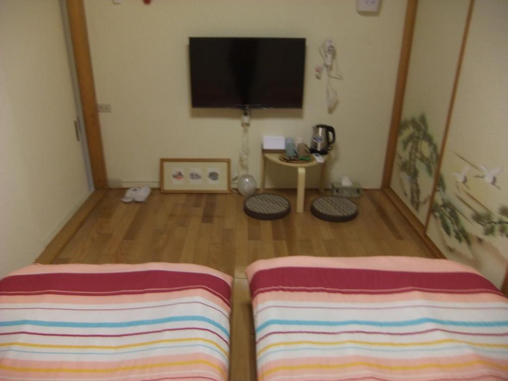 a living room with two striped pillows on the floor at Jiufen Hui Ming Homestay in Jiufen