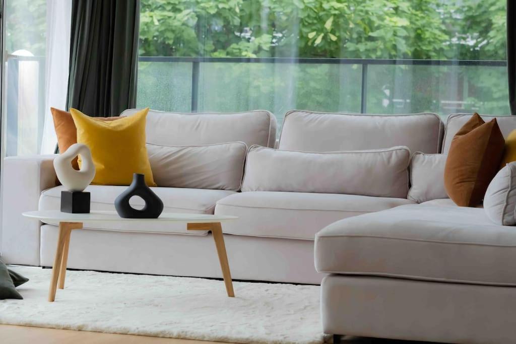 a white couch with pillows on it in a living room at LUXURY LUMINOUS 2bedroom apt CENTER of BRUSSELS in Brussels