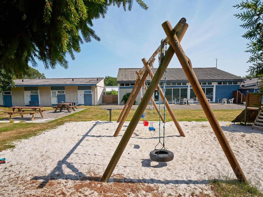a swing set in the sand in a park at Holiday home Nexø XLI in Neksø
