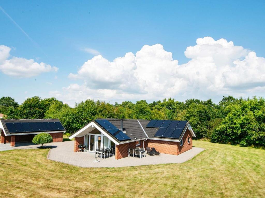 a home with solar panels on the roof at Holiday home Oksbøl LXXXIII in Oksbøl