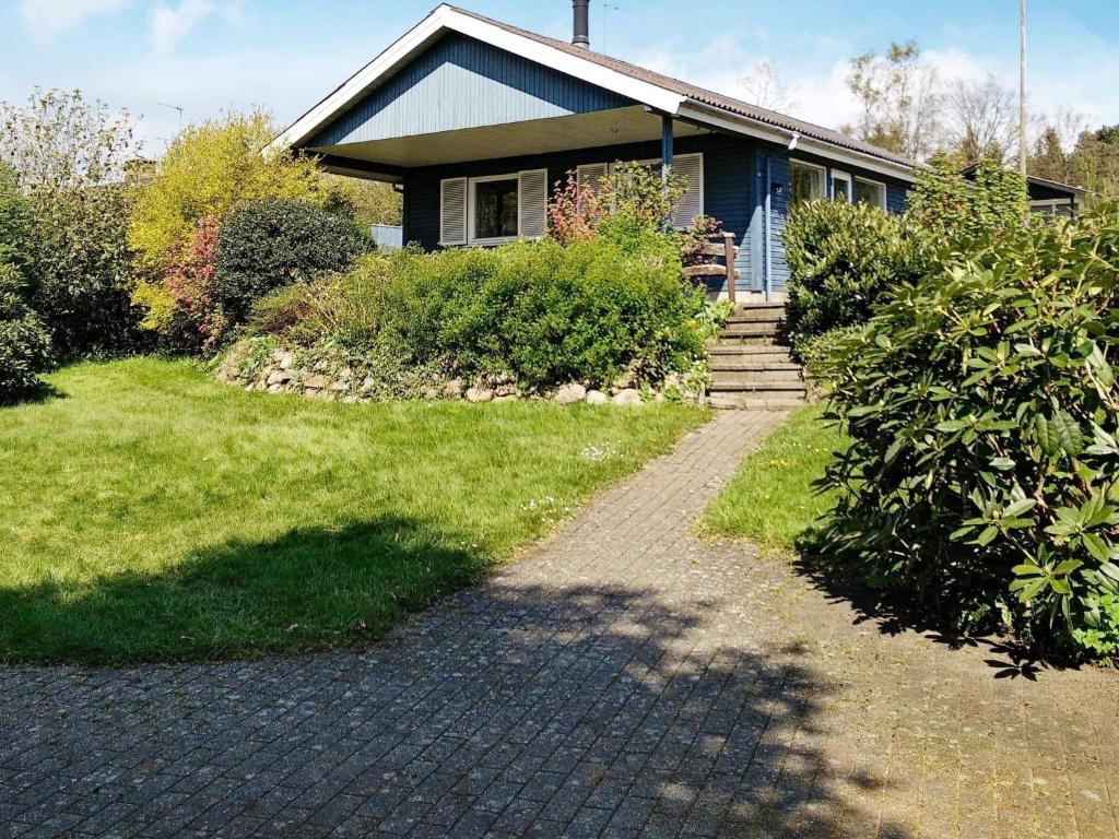 a house with a brick walkway in front of it at 6 person holiday home in B rkop in Børkop