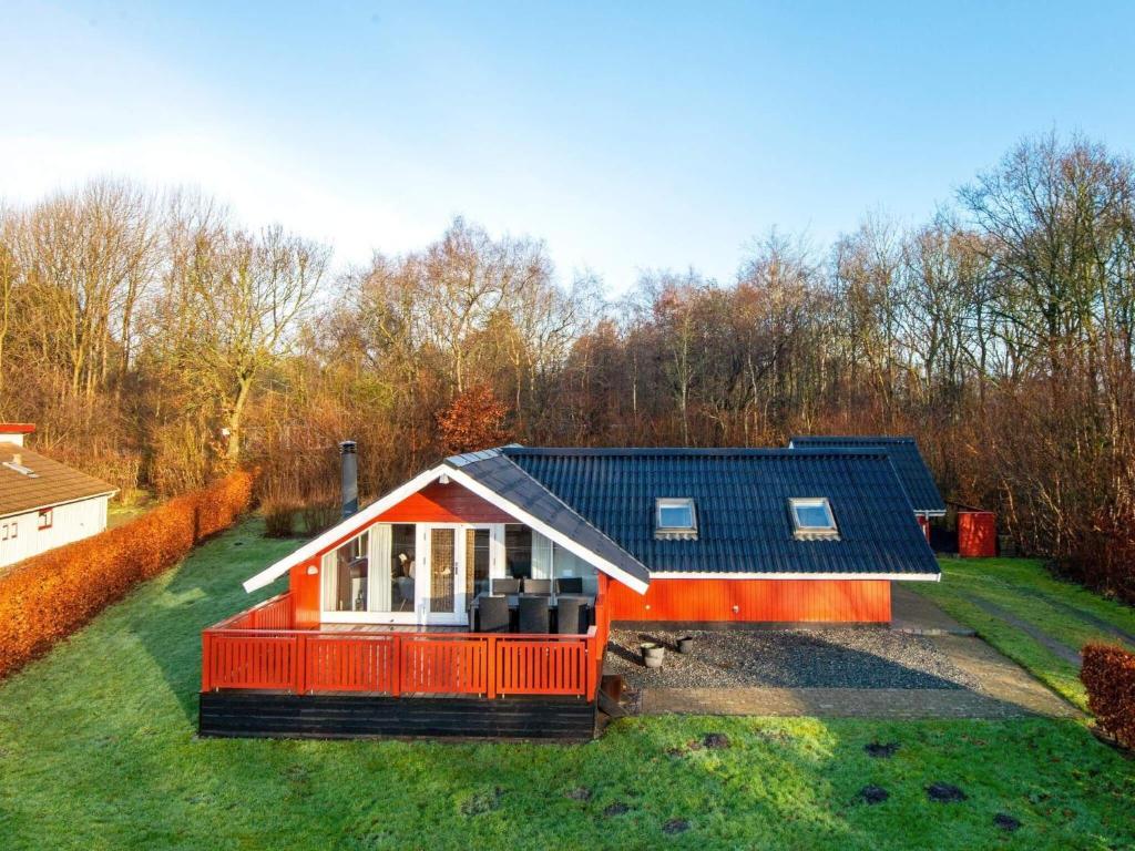 a small red house with a blue roof at 6 person holiday home in Toftlund in Toftlund