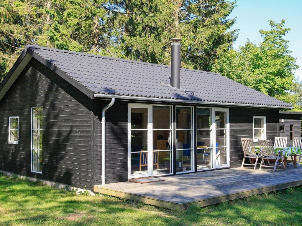 a small black cottage with a deck at 5 person holiday home in V ggerl se in Marielyst