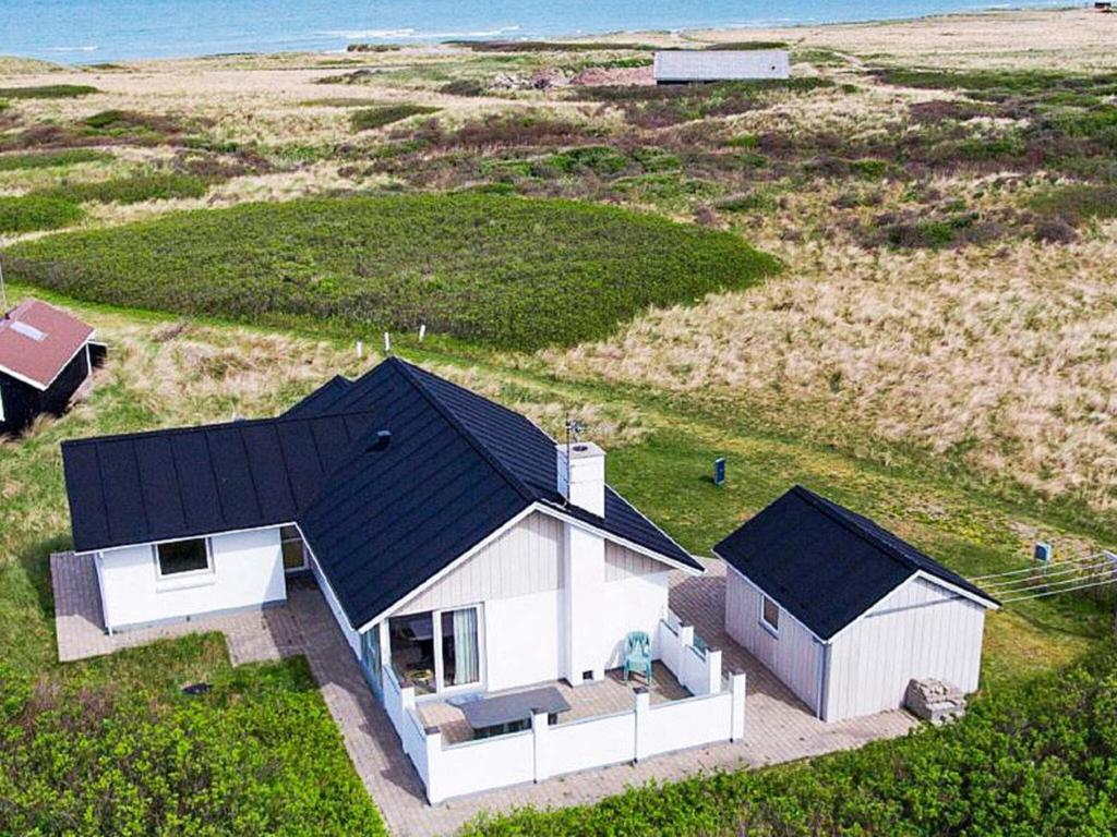 an overhead view of a white house with a black roof at 8 person holiday home in Hj rring in Hjørring