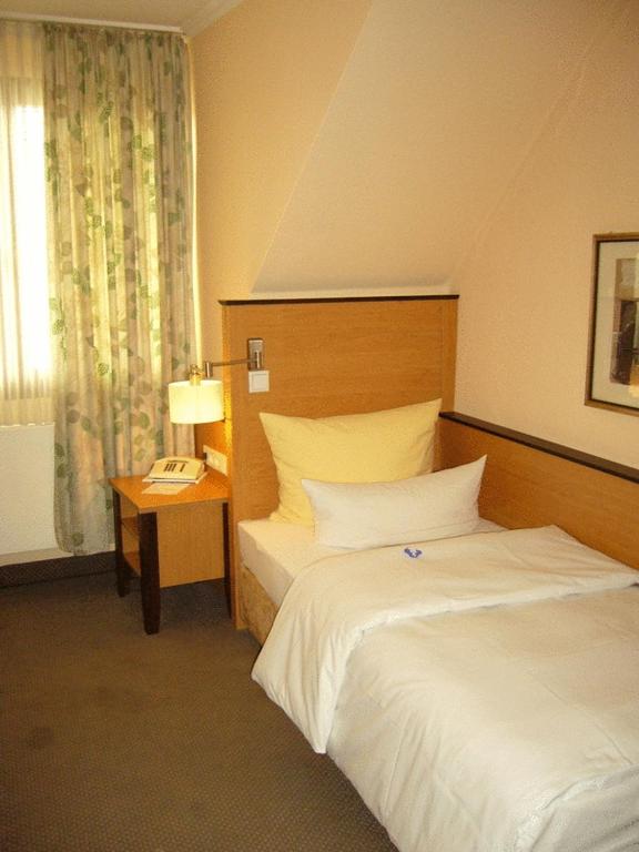Postel nebo postele na pokoji v ubytování Hotel Gasthof Vogelsang